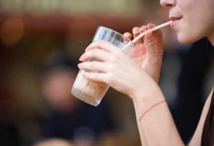 Woman drinking from straw